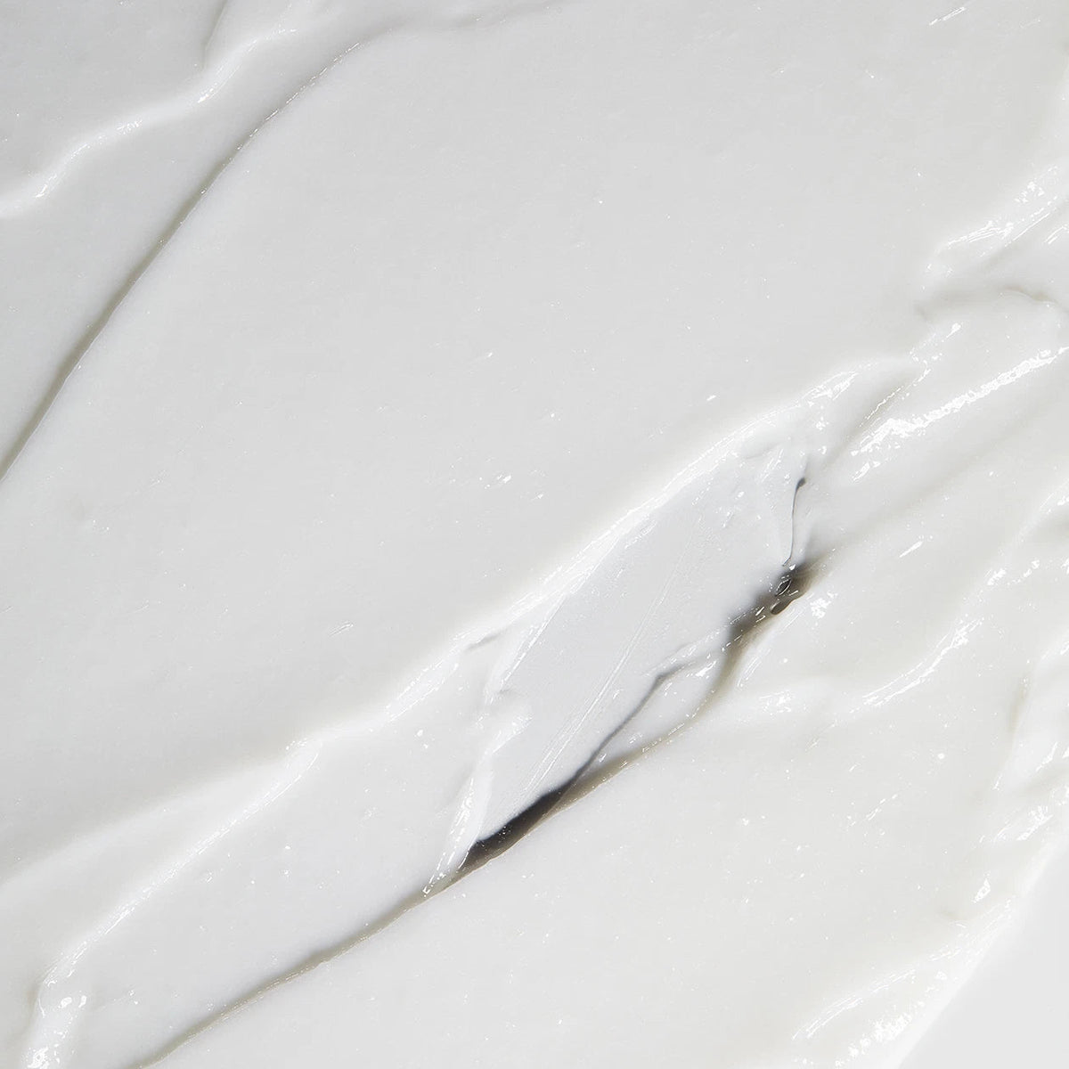 Obagi Nu-Derm Exfoderm skincare cream with a smooth, creamy texture in a white jar, designed for gentle exfoliation.