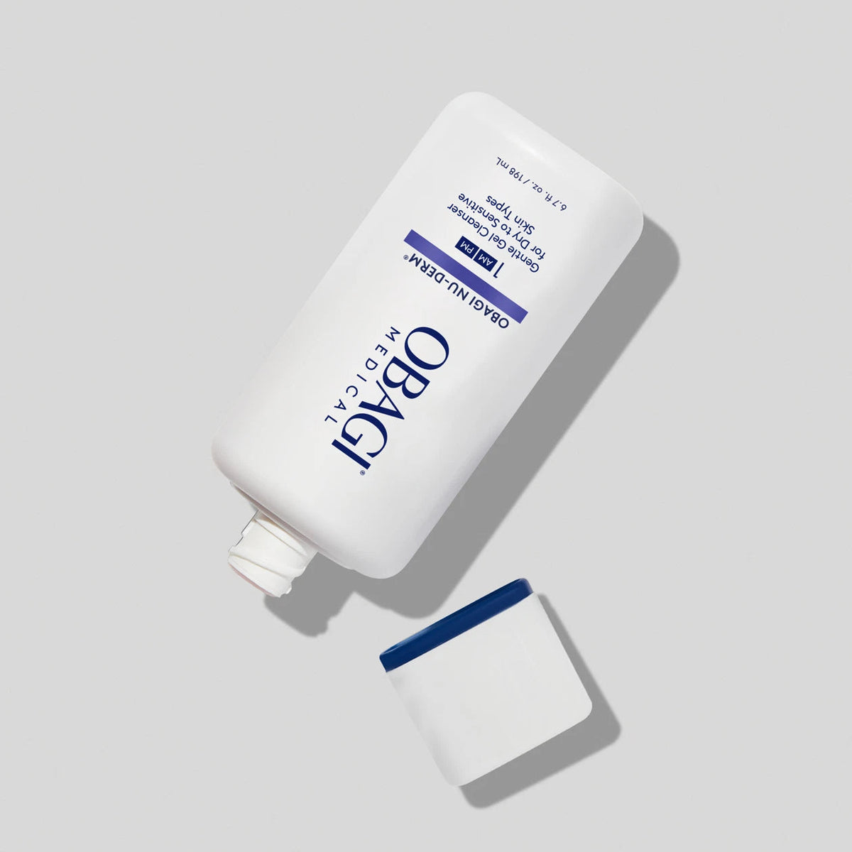 Obagi Nu-Derm Gentle Cleanser in open bottle, gentle skincare product for cleansing skin, with clear liquid and pump dispenser.