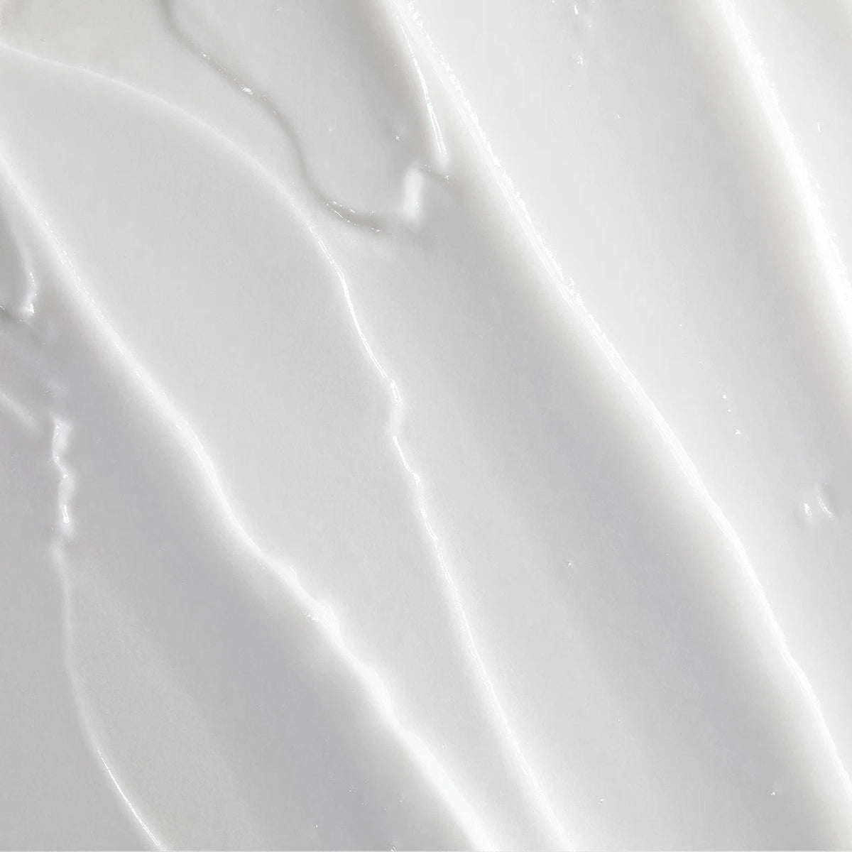 Obagi Nu-Derm Clear FX skincare cream showing smooth, creamy texture in a jar with a light-colored background.