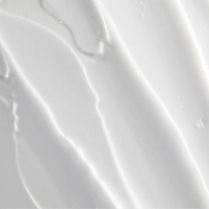 Obagi Nu-Derm Clear FX skincare cream showing smooth, creamy texture in a jar with a light-colored background.