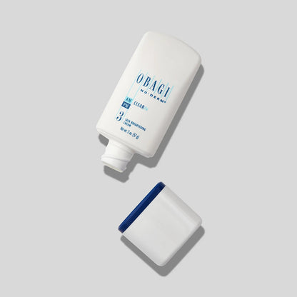 Open jar of Obagi Nu-Derm 3 Clear FX skincare cream showing the smooth, light-colored product inside the container.