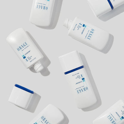 Obagi Nu-Derm Exfoderm skincare product in a white jar with a blue and white label, featuring a smooth, creamy texture.
