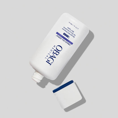 Obagi Nu-Derm Gentle Cleanser in open bottle, gentle skincare product for cleansing skin, with clear liquid and pump dispenser.