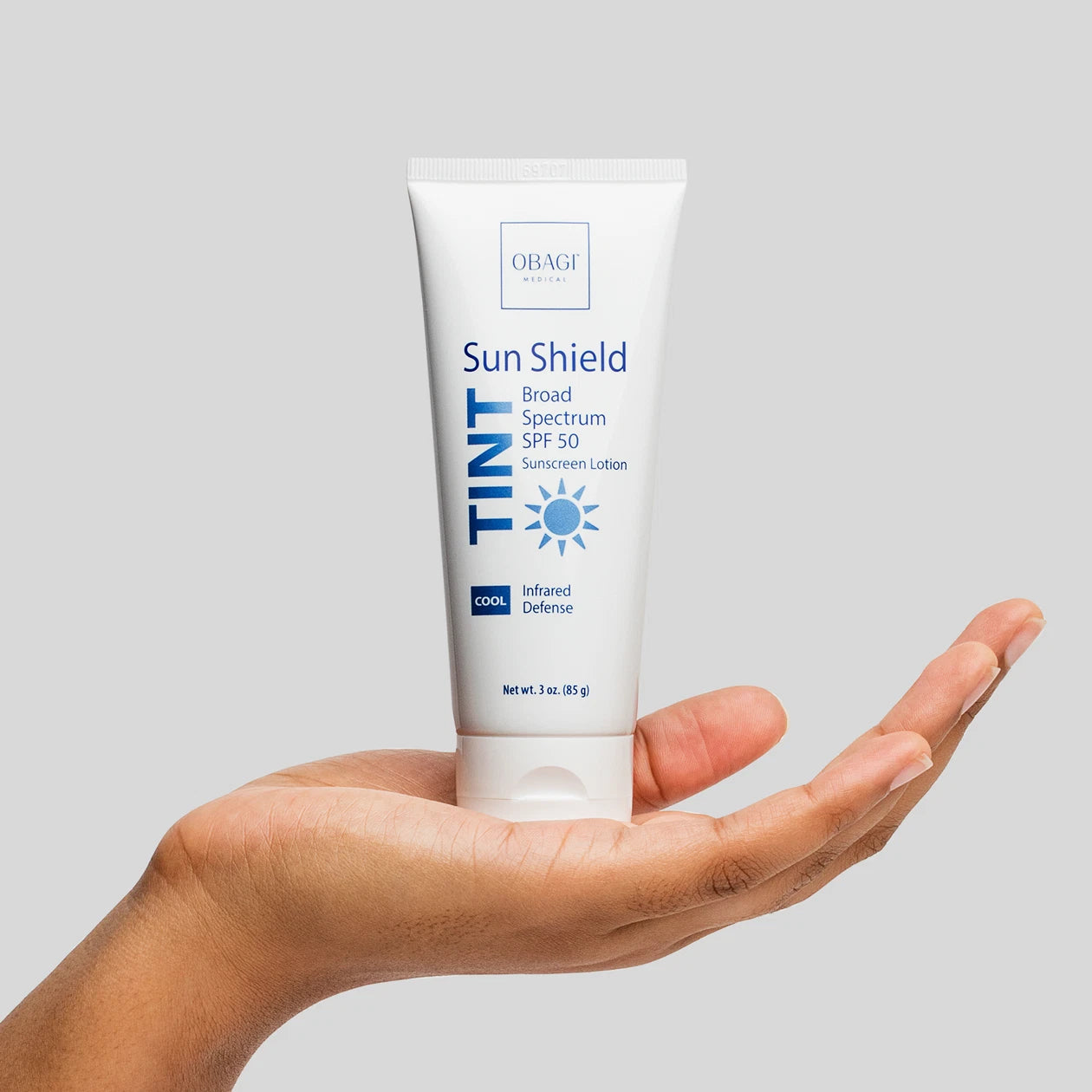 Obagi Sun Shield Tint SPF 50 Cool held in hand.
