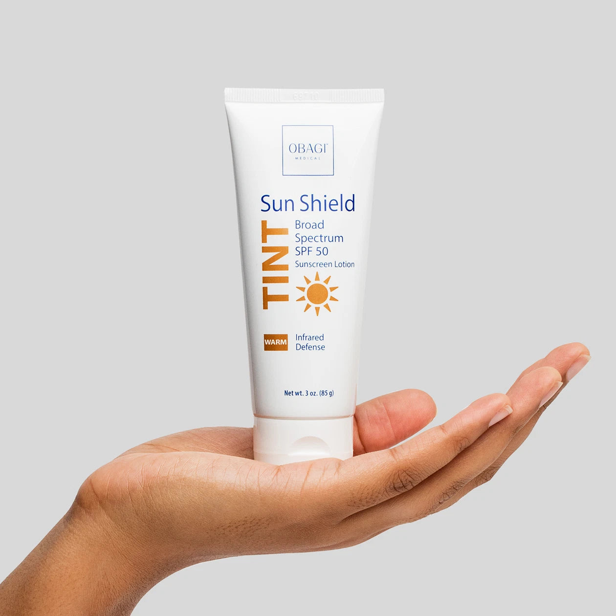 Obagi Sun Shield Tint SPF 50 Warm held in hand.