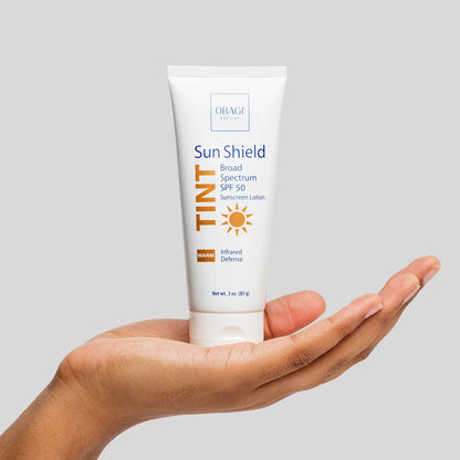 Obagi Sun Shield Tint SPF 50 Warm held in hand.